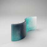 AQUA’s wave-form silhouette in light blue wax