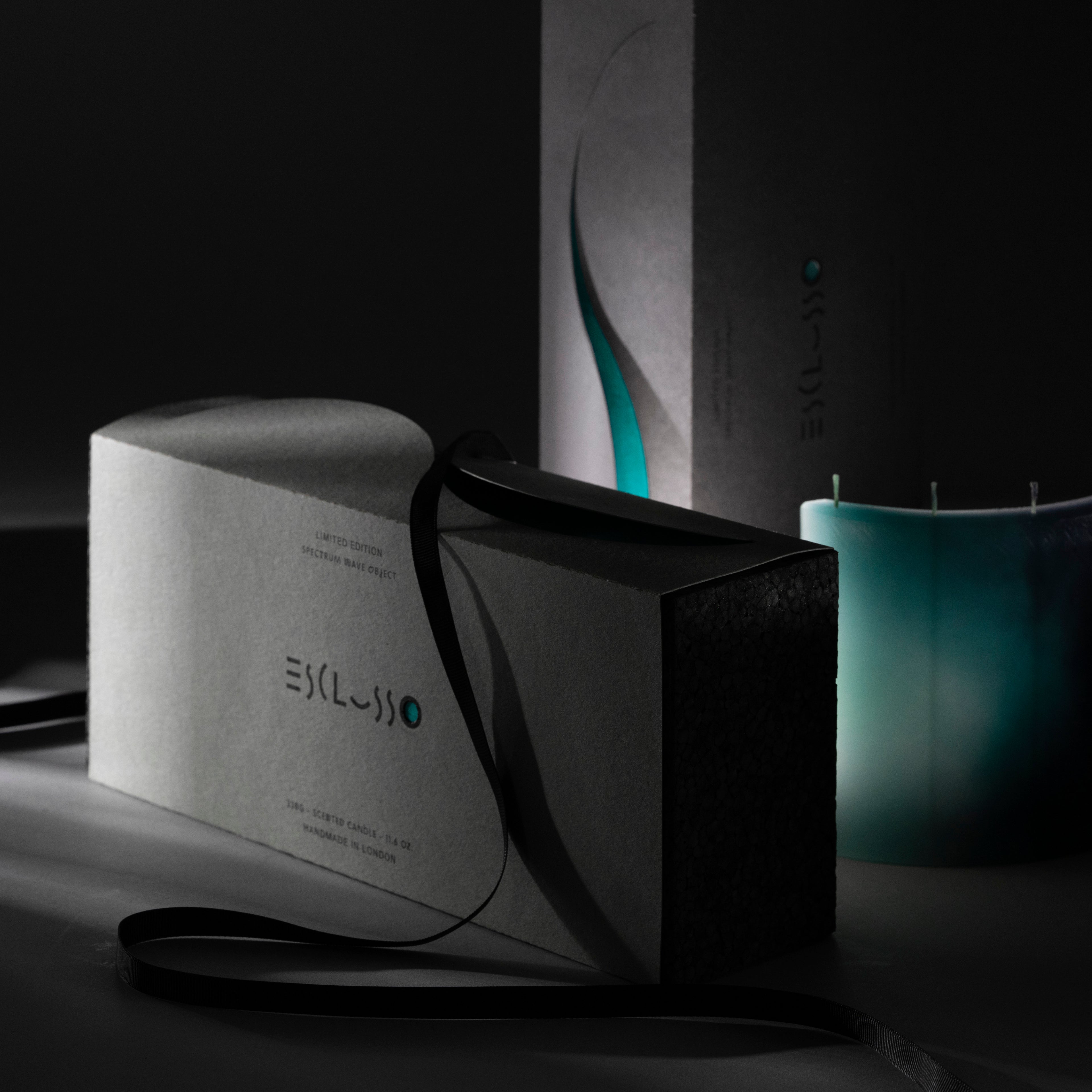 AQUA designer candle with ESCLUSSO branded packaging