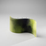 ESCLUSSO ESSA FORESTA statement candle—fluid wave-shaped design in rich green, black, and white hues. Inspired by ancient forests, evoking the mystery of towering trees and light-dappled canopies.