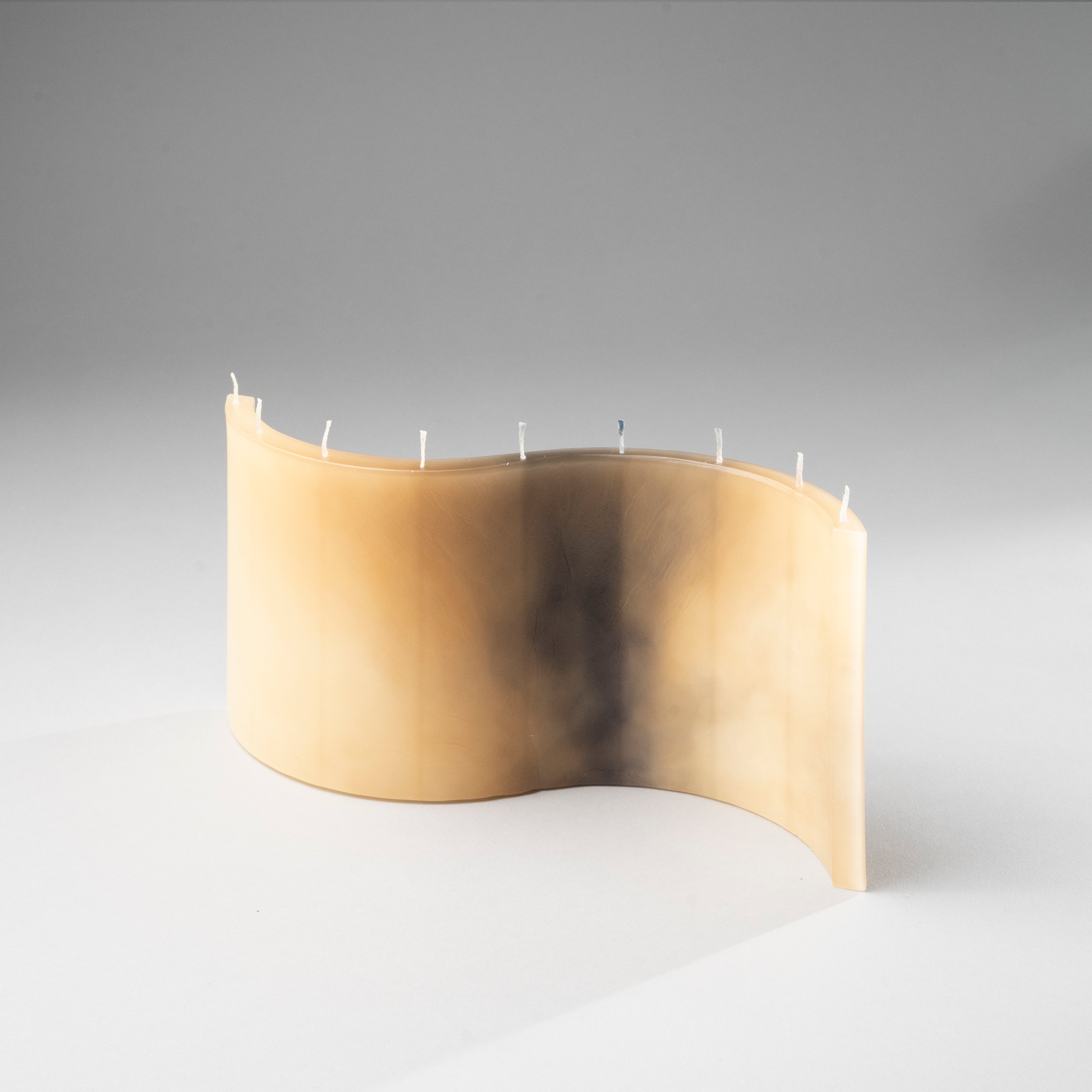 DUNE sand beige designer candle with sculptural wave silhouette