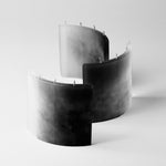 SILUETA ARCO TRIO LUNARIS, a composition of three handcrafted sculptural candle objects in monochromatic mineral-inspired pigments, designed for contemporary interiors.