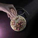 ESCLUSSO ROSE scented botanical wax sachet with natural pink rosebuds and botanical details embedded in ivory wax.